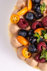 Fresh delicious homemade cake with berries on wooden table