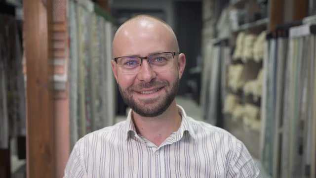Positive young man with glasses communicates via the Internet with his family.