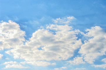 Picturesque white clouds against the textured blue sky. Natural background