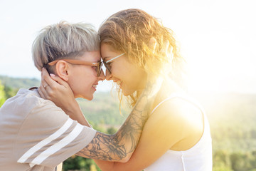 Beautiful lesbian young couple gently lovingly hugging, equal rights for the lgbt community,
