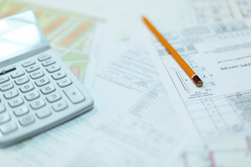 Rolled electrical diagrams, calculator, pencils and mathematical calculations for project, drawings for the projects engineer jobs