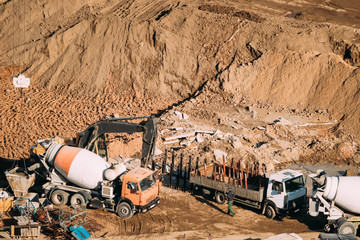 Minsk, Belarus. Special Concrete Transport Truck In-Transit Mixer Unit And Truck On City Building...