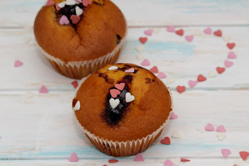 Two blueberries muffins or cupcakes on white texture
