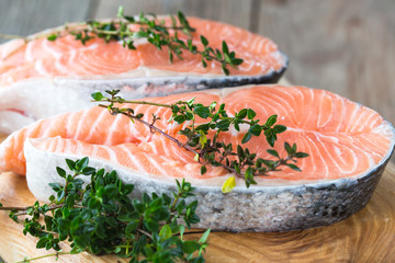 Salmon fish. Uncooked salmon fillet with ingredients for cooking - fresh lemon and spices on Wooden. Top view with copy space.
