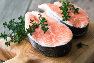 Salmon fish. Uncooked salmon fillet with ingredients for cooking - fresh lemon and spices on Wooden. Top view with copy space.