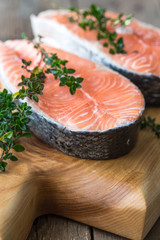 Salmon fish. Uncooked salmon fillet with ingredients for cooking - fresh lemon and spices on Wooden. Top view with copy space.