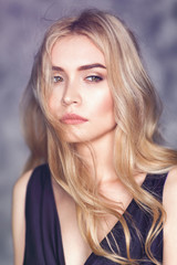 Fototapeta premium Portrait of a young beautiful girl with a pensive look, closeup