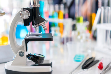 scientist with equipment and science experiments, laboratory glassware containing chemical liquid for research or analyzing a sample into test tube in laboratory