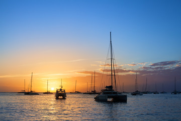 Beautiful sunset on the sea beach, boats, ships and yachts on water background
