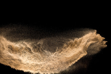 Golden dry river sand explosion isolated on white background. Abstract sand splashing. - obrazy, fototapety, plakaty