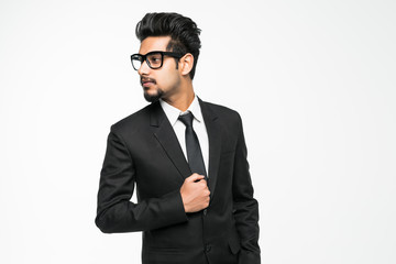Handsome indian man in glasses standing against white background