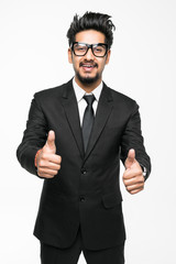 Portrait of indian businessman dressed in formal wear giving thumbs-up against white background