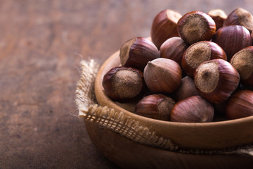 Hazelnuts and hazelnut shell on the wooden table.