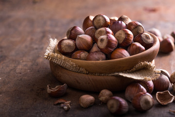 Hazelnuts and hazelnut shell on the wooden table.
