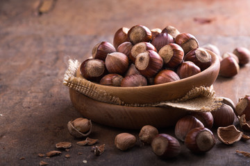 Hazelnuts and hazelnut shell on the wooden table.