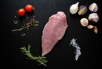 Raw chicken breast with herbs and spices