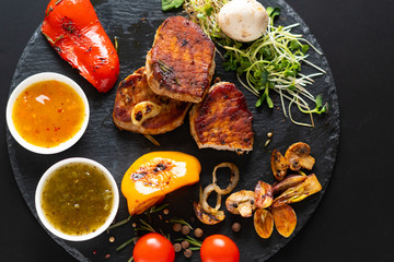 Serving of grilled pork fillet with vegetables