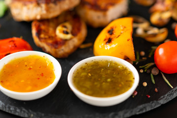 Two bowls of piquant dipping sauce or dressing