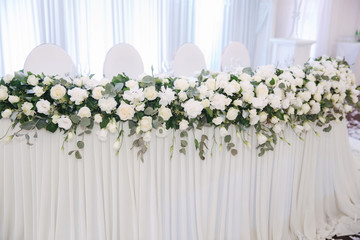 Floral decoration on the wedding table in the restaurant