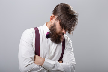 people, fashion and style concept - close-up portrait of young stylish male hipster on grey background