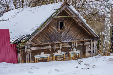 an abandoned wooden house with a slate roof
