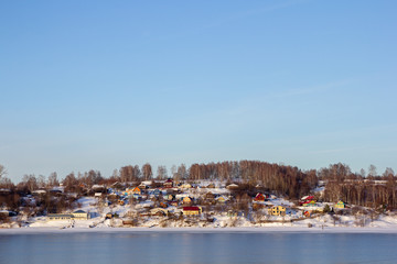 view of winter village on the river