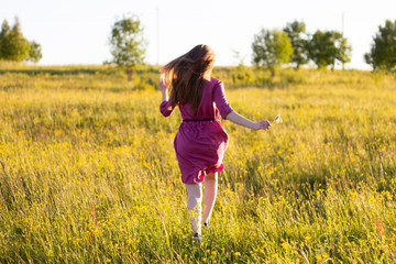 Naklejka na ściany i meble young woman runnig in the field