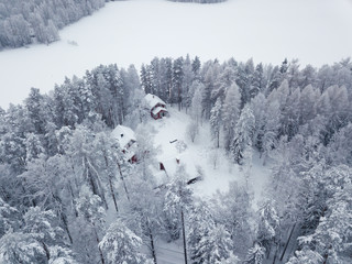 Aerial view of countryside houses in the forest near the lake in Finland