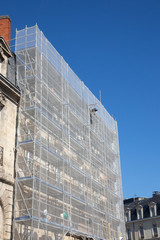 Fototapeta na wymiar Scaffolding of a construction site under blue sky