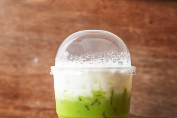 close up iced green macha tea wooden table