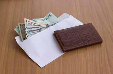 Corruption and bribery . Money in an envelope for signing the document.