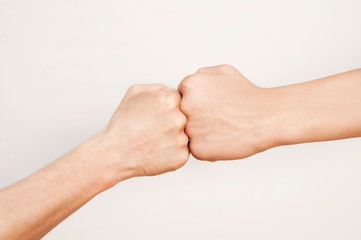 One fist against another on a light background. Concept of struggle, competition