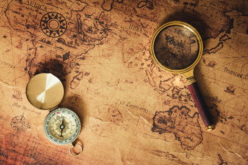 Fototapeta na wymiar Navigation Explore of Journey Planning., Travel Destination and Expedition Plan Vacation trip., Close Up of Layout Magnifying Glass, Compass on The World Map Background.
