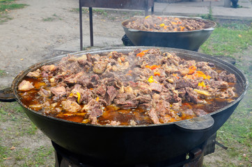Cauldrons full of stewed meat set on a moveable wood stoves