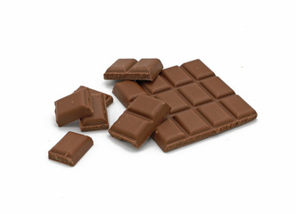 Milk chocolate bar and chocolate pieces isolated on white background