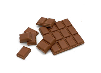 Milk chocolate bar and chocolate pieces isolated on white background