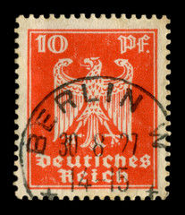 Germany - 30 Aug 1927: German historical stamp: coat of arms of the country - predatory eagle with black ink cancellation Berlin, Weimar Republic, Germany
