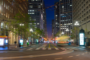 Market Street with it's tram lines and skyscrapers at dusk with street lights trails from moving vehicles in San Fransisco, US