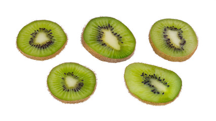 Fototapeta premium Green kiwi fruit slices. Fuzzy kiwifruit. Actinidia deliciosa. Isolated on white background. Group of sliced bio kiwis close-up. Brown skin and black seeds. Set of sweet-sour parts of tropical berry.