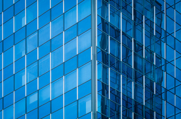 Fototapeta na wymiar Glass of modern tower for business background, blue tone
