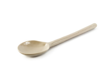 White ceramic spoon isolated on a white background.