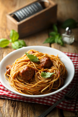 Pasta with meatballs and green basil