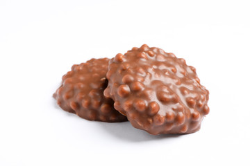 Chocolate cookies with caramel filling on white background
