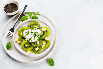 Kiwi salad with caramelized bananas. mint leaves and fresh yohgurt