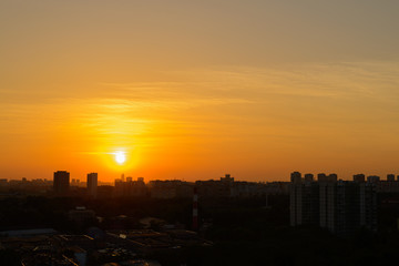 beautiful sunset over the big city with orange sky