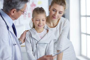 Little girl with her mother at a doctor on consultation
