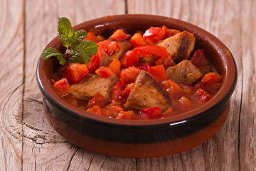 Marinated pork loin in tomato sauce.