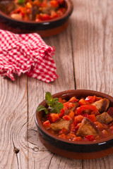 Marinated pork loin in tomato sauce.