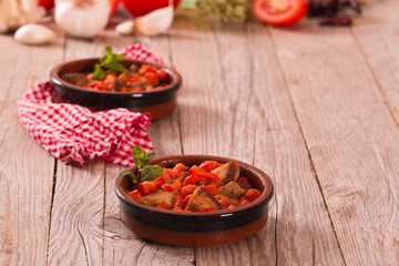 Marinated pork loin in tomato sauce.
