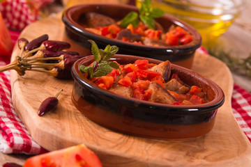 Marinated pork loin in tomato sauce.